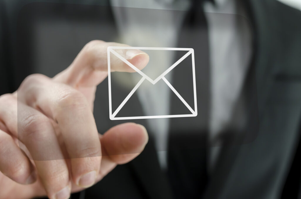 Icodewales Businessman touching email icon